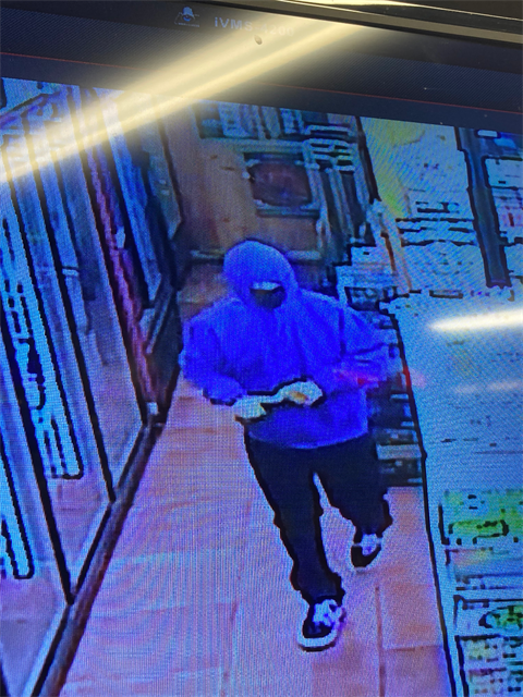 Photo of suspect in light purple hoodie and ski mask