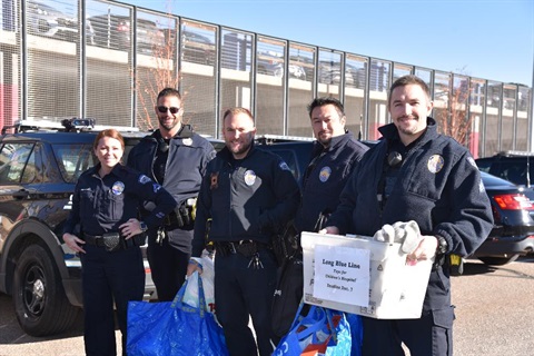 Police Officers holding gifts for kids