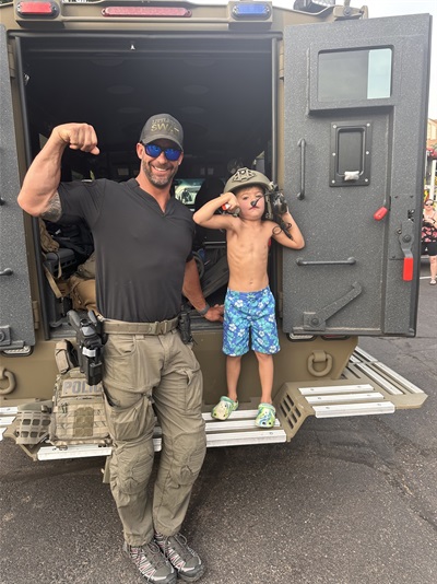 SWAT Officer and Kid with the Bear Cat